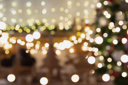 Abstract composition. Beautiful blurred Christmas interior with fireplace, wood mantelpiece, lit up...