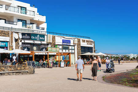 COSTA TEGUISE, LANZAROTE - 26 December 2018. Cafes and shops in Las Cucharas beach, Canary islands,...