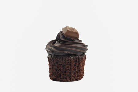 Chocolate cupcake with buttercream frosting on white background, selective focusの写真素材