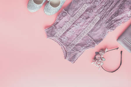 Girls fashion background in pastel colors, lace dress, sparkly shoes, flower headband, flat lay, top view, toned photo, copy space for text, selective focusの写真素材