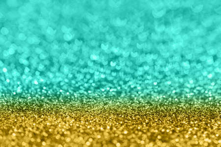 Abstract composition. Turqupose and golden glitter light background with beautiful bokeh, selective...