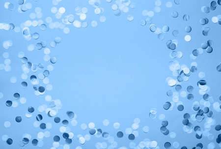 Paper confetti in trendy classic blue shades, on pastel background, top view, selectiveの写真素材