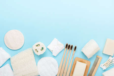 Zero waste with natural biodegradable self care products on blue. Bamboo toothbrushes, handmade soap...