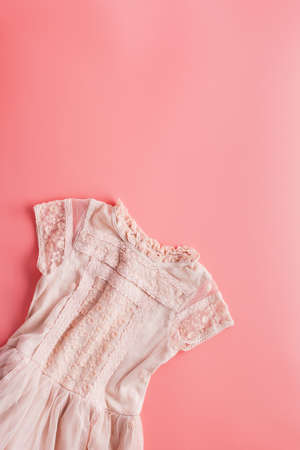 Girls fashion background in pastel pink, lace dress, flat lay, top view, toned photo, copy space for text, selective focusの写真素材