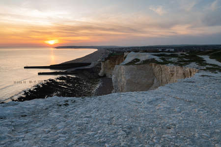 Seaford, East Sussex, England. View of the white chalk cliffs to the west in the evening sunset, part of Seven Sisters National park, selective focusの写真素材