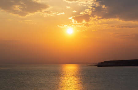 Seaford, East Sussex, England. View of the sea and Newhaven from the beach the west in the evening sunset, East Sussex, Englandの写真素材