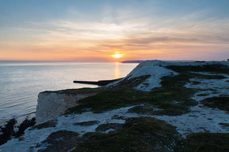 Seaford, East Sussex, England. View of the white chalk cliffs to the west in the evening sunset, part of Seven Sisters National park, selective focusの写真素材