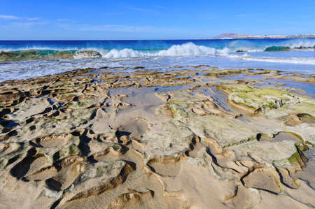 View of beautiful Papagayo beach, blue sea, yellow sand, cliffs. Playa Blanca town, Lanzarote,...