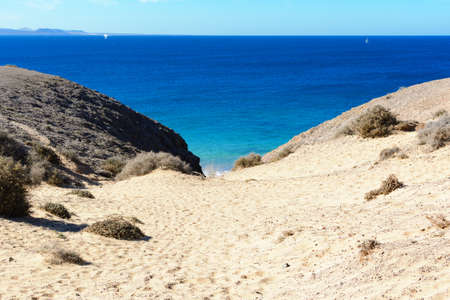 View of beautiful Playa de la Cera beach, from above, blue sea, yellow sand, cliffs. Papagayo, Playa...