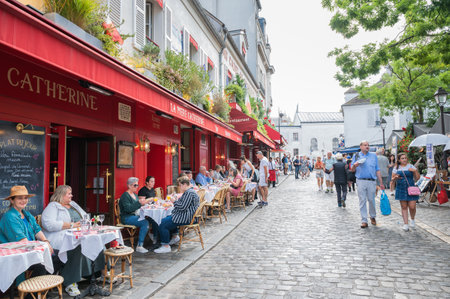 Paris, France - August 26 2022: People, artists, shops in Mormartre village, famous for its artistic...