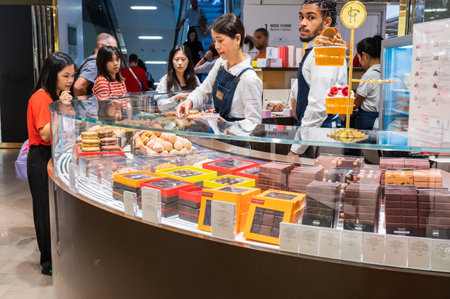 Paris, France - August 26 2022: Interiors in Galeries Lafayette. Shop selling french sweets including famous almond macarons.のeditorial素材