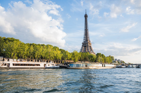 Paris, France - August 26 2022: View of Eiffel tower from the river cruise boat near the bridge...