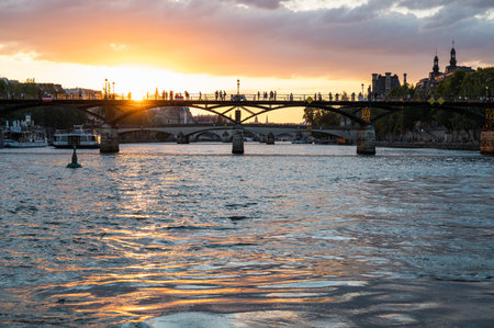 Paris, France - August 26 2022: Sunset at Bridge Pont des Arts, pedestrian bridge that has international reputation as the bridge of romance.のeditorial素材