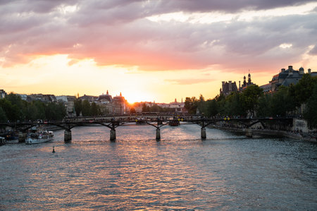 Paris, France - August 26 2022: Sunset at Bridge Pont des Arts, pedestrian bridge that has international reputation as the bridge of romance.のeditorial素材