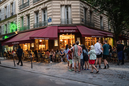 Paris, France - August 27 2022: People walking and dining in cafe in the evening in famous the Marais district in Paris, authentic Paris neighbourhood, selective focusのeditorial素材