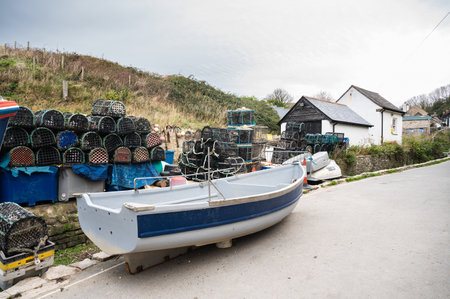 Fishing boats in seaside village near Lulworth Cove in Dorset, United Kingdom. Cloudy autumn dayの写真素材