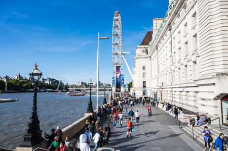 London, United Kingdom - September 17 2022: people walking towards London Eye ferris wheelのeditorial素材