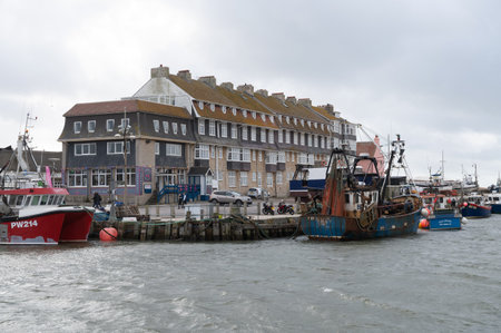 West Bay, United Kingdom - October 29 2022: Boats in West Bay harbour in Dorset, South West, United Kingdom, selective focusのeditorial素材