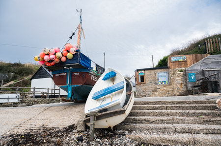 Lulworth, United Kingdom - October 31 2022: Fishing boats in seaside village near Lulworth Cove in Dorset, United Kingdom. Cloudy autumn dayのeditorial素材