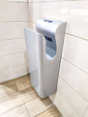 Under the epidemic situation of corona virus, Vertical hand dryer in public restroom WC. May be one of the sources of the spread of The coronavirus disease (COVID-19)のeditorial素材
