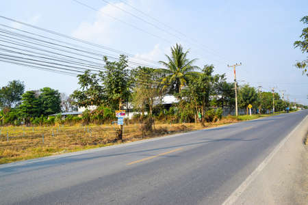 Kanchanaburi, Thailand - January 28, 2018. Asphalt road. Landscape with sky with clouds. Travel background. Highway in asiaのeditorial素材