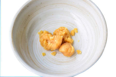 Palm sugar in a brown cup on a white background. Asian food ingredientの写真素材