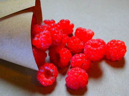 ripe raspberries in a paper bag