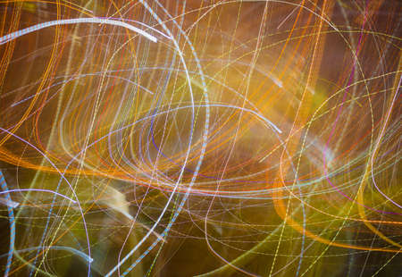The blurred animation of light lines and colors on city streets at night, which has a variety of...