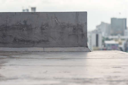 Concrete wall , located on the rooftop of the building
