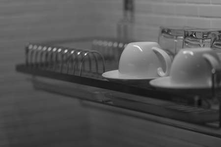 The black and white image of two cups of coffee placed on the shelves.の写真素材