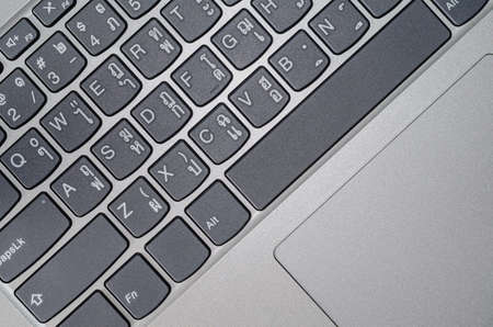 Picture of a computer keyboard, which has a gray keycap with a metal keyboard frame Usually, which is the standard of the keyboard using the primary letters are English and the letters of the product's delivery are Thai characters.の写真素材