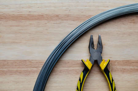 Hand tools, pliers, made from metal materials, so it has good properties for use in cutting wire is placed on the softwood background.の写真素材