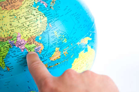 Finger pointing Thailand on the global mapの写真素材