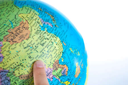 Finger pointing China on the global map