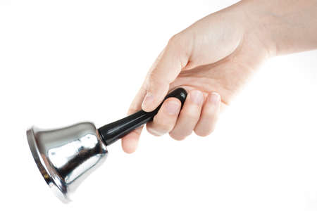 Close-up of a hand with bell isolated on whiteの写真素材