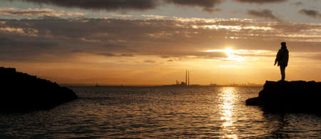 Sunset backlit with human silhouette in Howth, Dublin  Irelandの写真素材