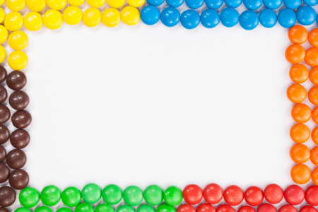 Colorful Chocolate candies frame whith white space