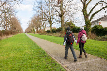 couple holding hands walking in a mallの写真素材