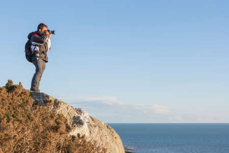 Photogragpher backpacker at the cliff