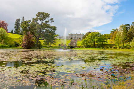 Enniskerry, Ireland - May 11, 2014: Fountain of the Triton Lake in the Italian Garden at Powerscourt State. Powerscourt State was voted the third garden in the World by National Geographic in Sniskerry, Ireland on May 11, 2014のeditorial素材
