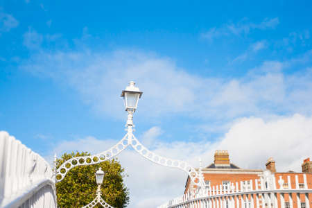 Streetlight on Hapenny Bridge against blue sky in Dublin, Ireland
