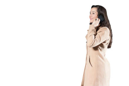 Beautiful woman talking by phone isolated on white backgroundの写真素材