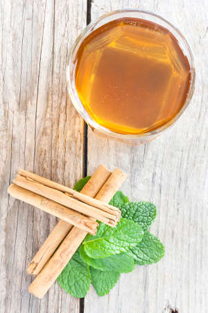 Close-up of a cup of tea with cinnamon and peppermintの写真素材