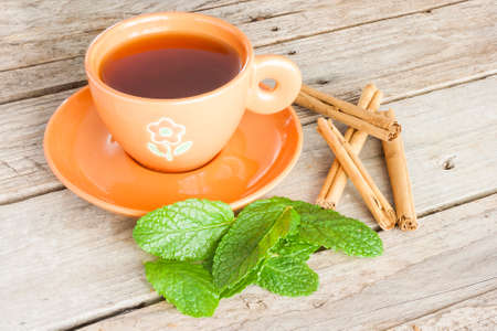 Close-up of a cup of tea with cinnamon and peppermintの写真素材