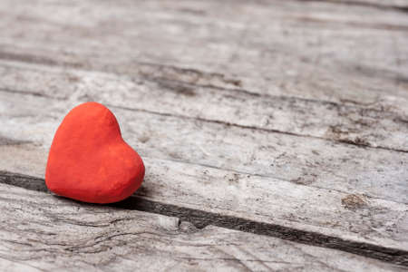 Vintage heart on wooden old table backgroundの写真素材