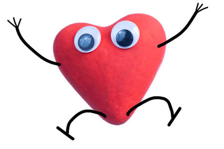 Red heart character jumping of happiness isolated on white backgroundの写真素材