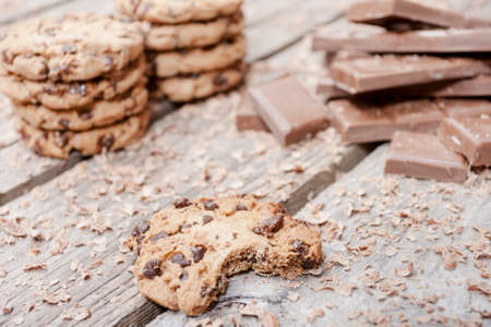 Bitten homemade chocolate chip cookies on wooden backgroundの写真素材