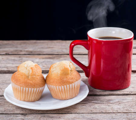 Hot coffee and cupcakes ready for breakfastの写真素材