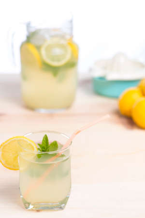 Glass of natural lemonade just squeezed on wooden tableの写真素材