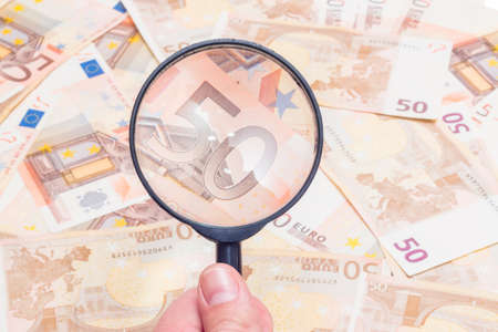 Closeup of fifty euro notes through magnifer backgroundの写真素材